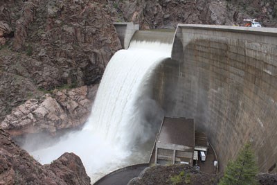 Water cascades over a dam's spillway.