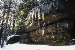 Snow and icicles hang from Ledges