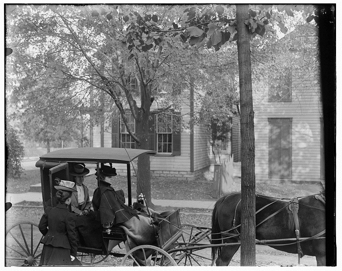 Katharine Wright, Harriet Silliman, and Agnes Osborne in horse-drawn carriage across from Wright home, 7 Hawthorn Street, Dayton, Ohio-ca 1899 s