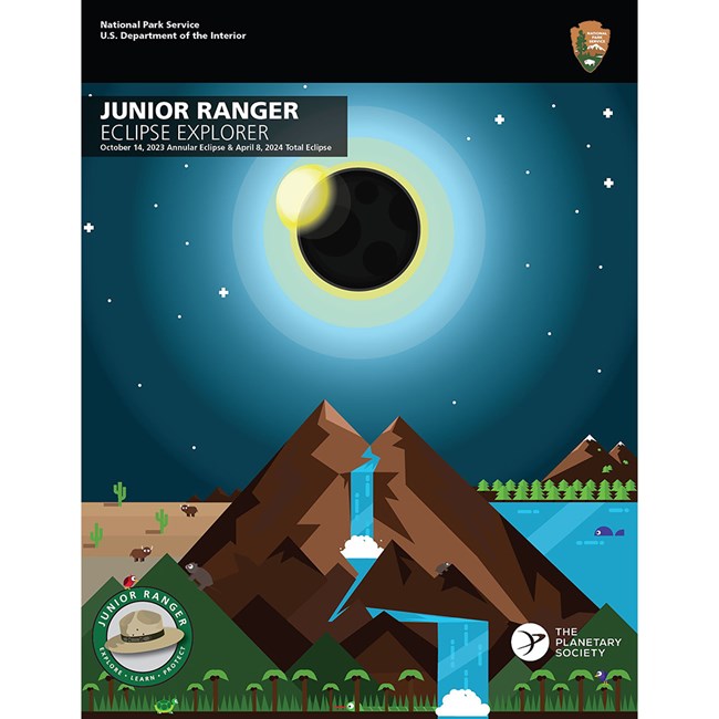Cover of Junior Ranger Eclipse Explorer book showing eclipse, mountain, waterfall, forest and wildlife in a cartoon style.