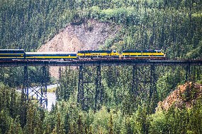 An Alaska Railroad train crosses a trestle above Hines and Riley Creeks