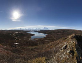 View from hills north of Wonder Lake, with lake in middle ground and Alaska Range in background