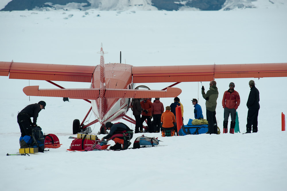 An expedition unloads climbing gear from their airplane at the Kahiltna Basecamp