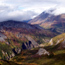 Image of tundra covered mountains with the sulmmits obscured by clouds