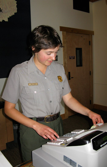 A park ranger selling entrance passes