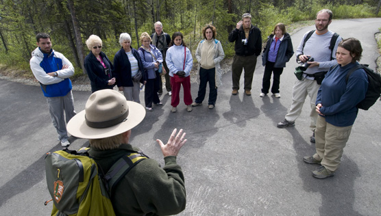 Visitors gather behind the Denali Visitor Center with a ranger