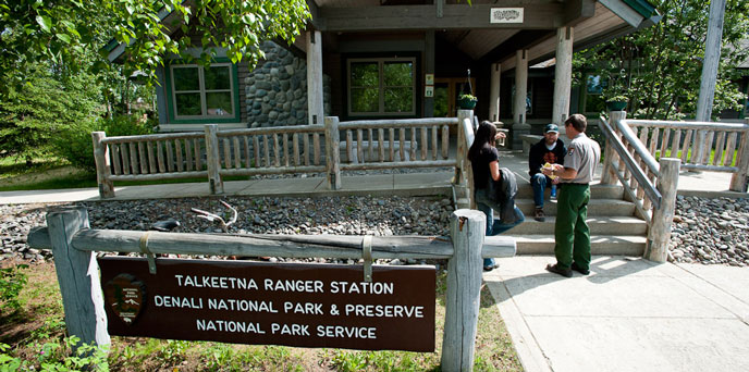 visitors and a ranger outside a visitor center