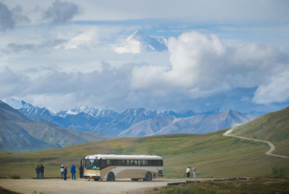 A Tundra Wilderness Tour - one of the three kinds of interpretive tour buses - stops at Stony Dome to view Mt. McKinley