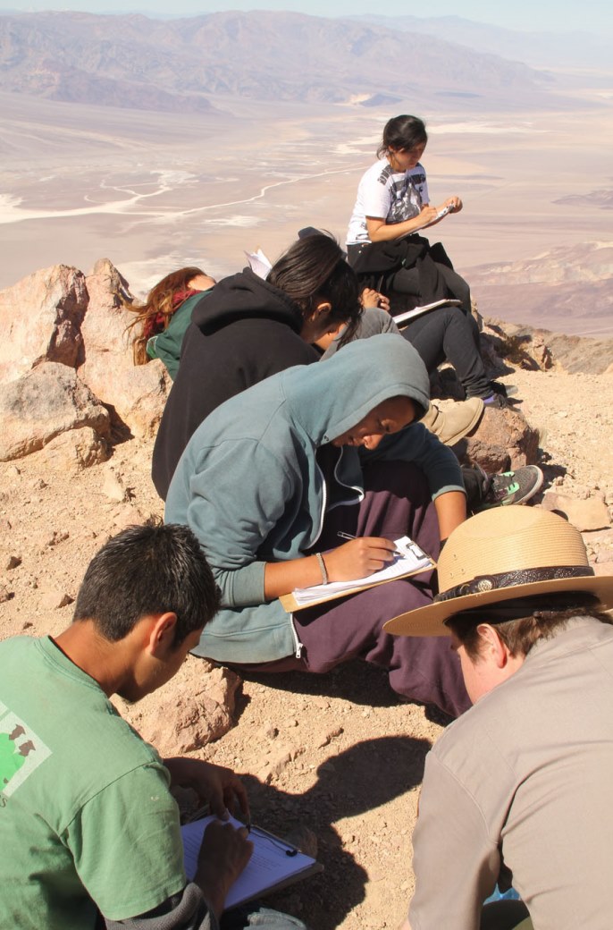 Students participate in a field trip activity with a park ranger.