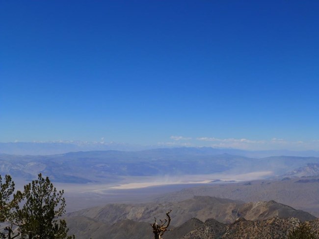 The view from the highest point in Death Valley to snow covered mountains on the horizon.