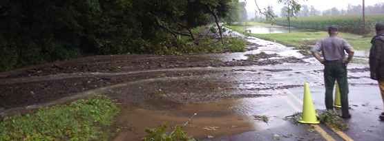 road covered with debris after flooding