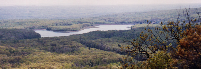 A resrvoir in the distance seen from on top of a mountain