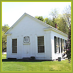 Exterior of a white wood church without a tower