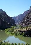 A river flows into a deep and narrow river canyon.