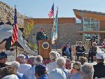 Dinosaur NM Superintendent Mary Risser speaking at Quarry Visitor Center ribbon-cutting ceremony.