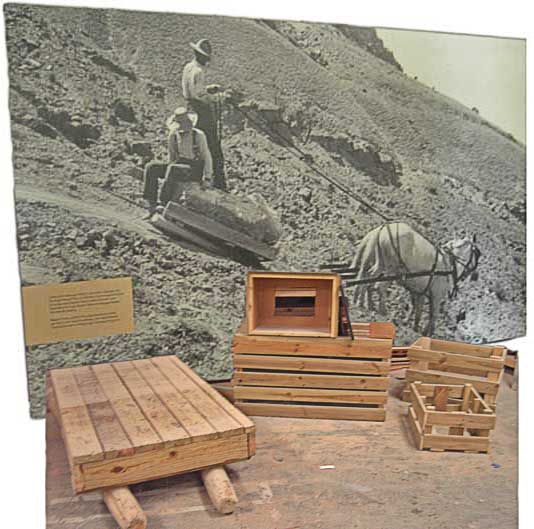 Historic photo mural, a wooden skid, and crates.