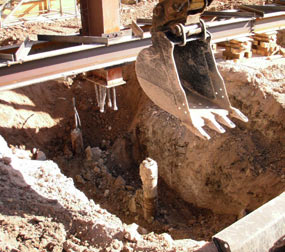 Large hole excavated under a column.