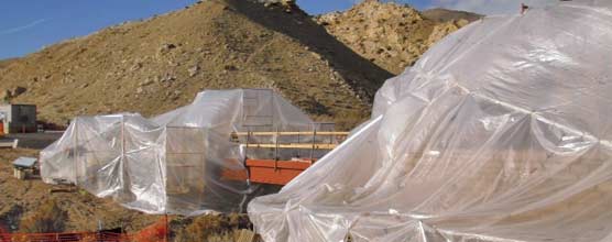 Plastic is draped over scaffolding on either end of the pedestrian bridge. 