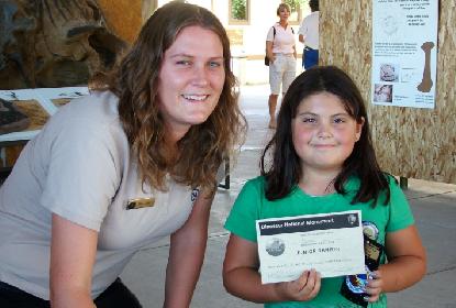 Child poses with Dana Chandler, program creator.