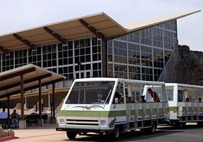 Passengers disembark from the shuttle at the Quarry Exhibit Hall.