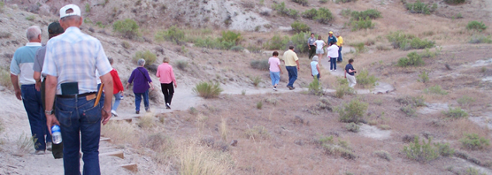 Hiking to an area to see dinosaur fossils.