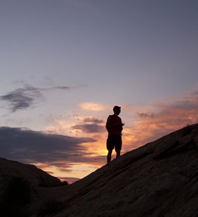 A visitor enjoying sunset on the Sound of Silence Trail.