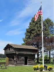 Log fort with American flag.