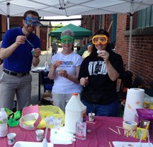 Chemists in colorful goggles ready to do an experiment with kids.