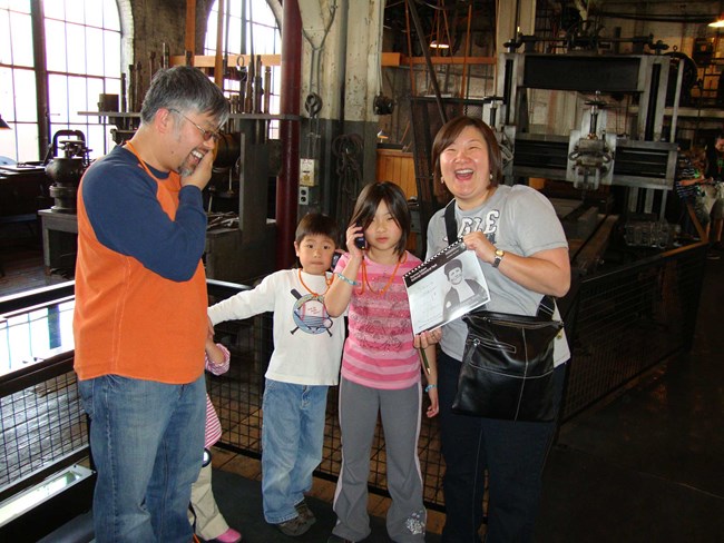 The Terrell family in the machine shop learning about Thomas Edison and working on the Junior Ranger booklet.