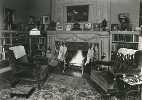 The Edison family living room with the stockings hung by the fire.
