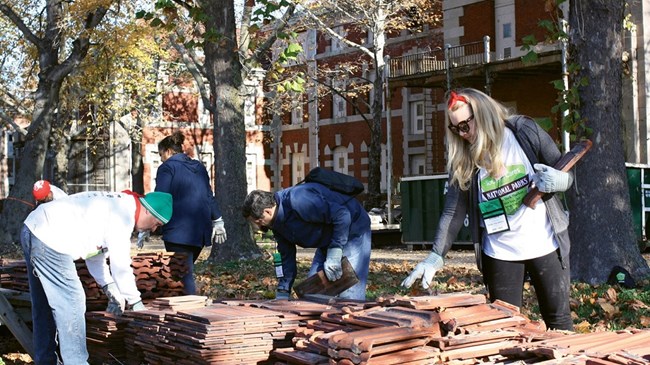 A group of volunteers pick up trash at Ellis Island