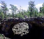 A lava bridge soars over a chasm.