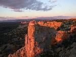 Cliffs glow red in the light of the setting sun.