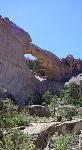 A stone arch is carved out of a cliff