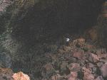 A dark cave passage in lava