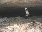 A caver explores a section of lava tube