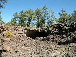 A cave entrance seen across lava