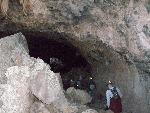 Cavers enter a narrow passage