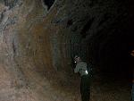 A cave wall is colorfully stained