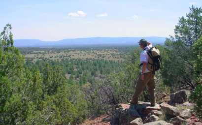 A hiker takes in the views from a ridge near El Calderon on the Continental Divide Trail.