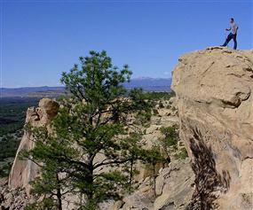 A hiker enjoys the view from the Sandstone Bluffs Overlook