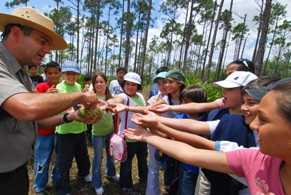 Ranger passing out periphyton to students