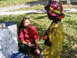 Firefighter teaching child about fire