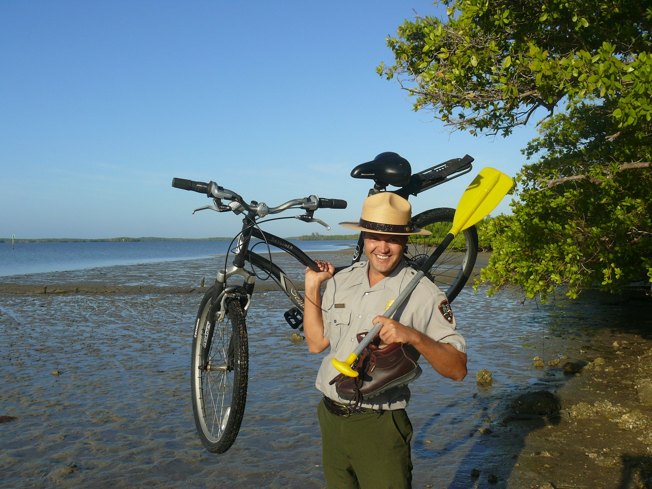 A ranger holds a bicycle