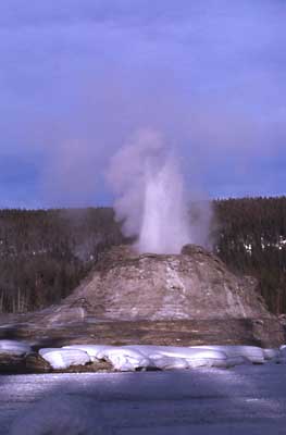 a jet of water erupts from Castel Geyser's huge cone