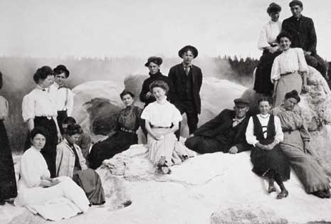 Tourists gather near the vent of a geyser in the historic photograph