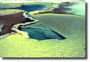 Doublet Pool has a strikingly complex series of ledges, deep blue water and an elaborate border of colorful deposits.