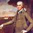 Portrait image of General William Floyd standing on lawn in front of his manor house.