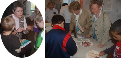 Volunteers help children with horseshoe crab crafts.