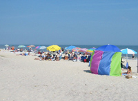 Crowds on beach with colorful umbrellas. Crowds on beach with colorful umbrellas.